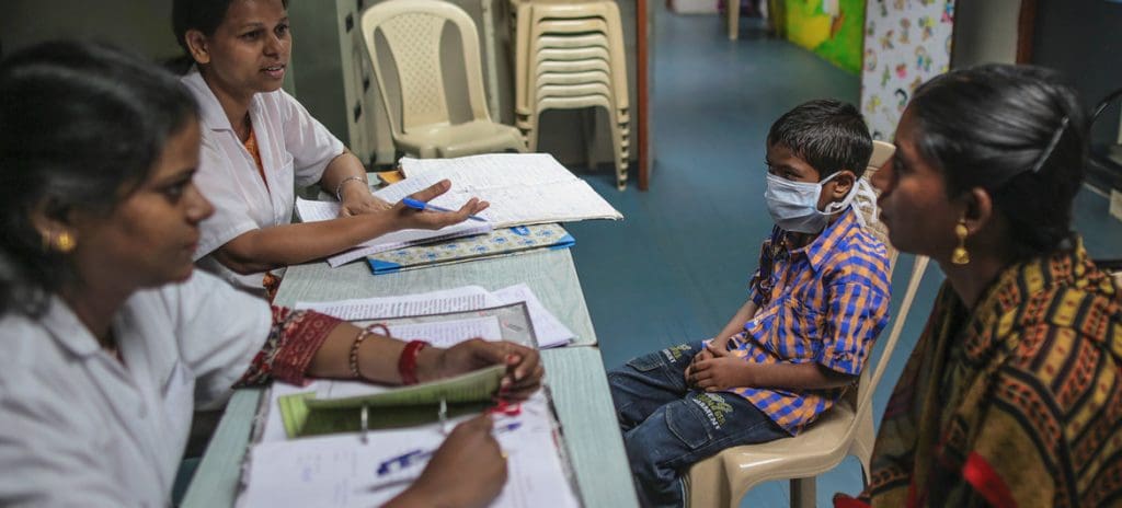 Counsellors talk with the mother of a nine-year-old boy at a Pediatrics Antiretroviral Therapy (ART) Centre at a hospital in Mumbai, India